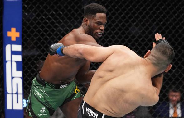 AJ Dobson punches Jacob Malkoun of Australia in their middleweight fight during the UFC 271 event at Toyota Center on February 12, 2022 in Houston, Texas. (Photo by Josh Hedges/Zuffa LLC)