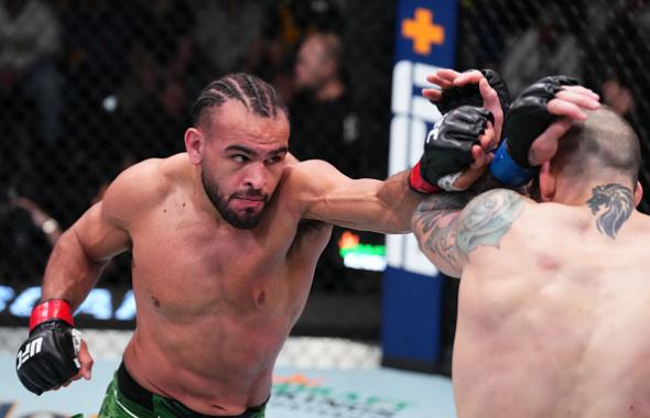 Gabe Green punches Yohan Lainesse of Canada in a welterweight fight during the UFC Fight Night event at UFC APEX on April 30, 2022 in Las Vegas, Nevada. (Photo by Chris Unger/Zuffa LLC)