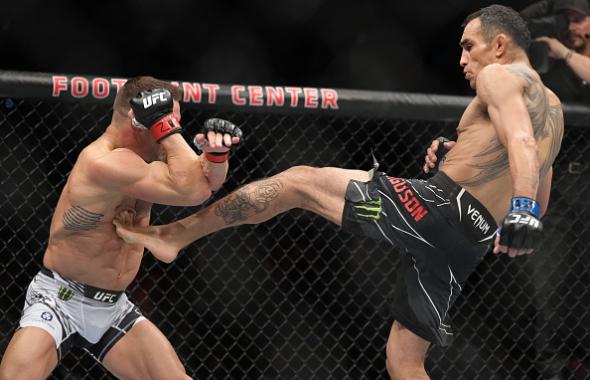 Tony Ferguson kicks Michael Chandler in a lightweight fight during the UFC 274 event at Footprint Center on May 07, 2022 in Phoenix, Arizona. (Photo by Jeff Bottari/Zuffa LLC)