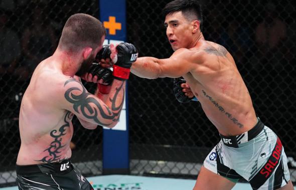 Luis Saldana punches Austin Lingo in a featherweight fight during the UFC Fight Night event at UFC APEX on August 21, 2021 in Las Vegas, Nevada. (Photo by Chris Unger/Zuffa LLC)