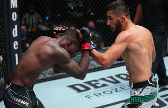 Saidyokub Kakhramonov of Uzbekistan punches Trevin Jones of Guam in a bantamweight fight during the UFC Fight Night event at UFC APEX on August 21, 2021 in Las Vegas, Nevada. (Photo by Chris Unger/Zuffa LLC)