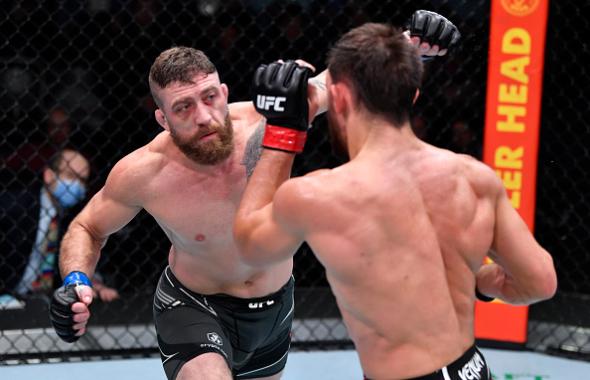 Gerald Meerschaert punches Dustin Stoltzfus in their middleweight fight during the UFC Fight Night event at UFC APEX on December 18, 2021 in Las Vegas, Nevada. (Photo by Jeff Bottari/Zuffa LLC)