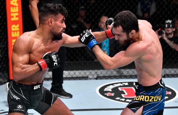 Khalid Taha of Germany punches Sergey Morozov of Kazakhstan in their bantamweight bout during the UFC Fight Night event at UFC APEX on July 17, 2021 in Las Vegas, Nevada. (Photo by Jeff Bottari/Zuffa LLC)