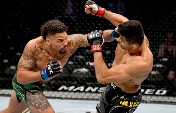 Andre Muniz of Brazil is punched by Eryk Anders in their middleweight bout during the UFC 269 on December 11, 2021 in Las Vegas, Nevada. (Photo by Jeff Bottari/Zuffa LLC)