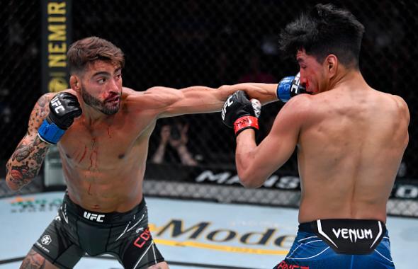 Randy Costa punches Adrian Yanez in their bantamweight fight during the UFC Fight Night event at UFC APEX on July 24, 2021 in Las Vegas, Nevada. (Photo by Jeff Bottari/Zuffa LLC)