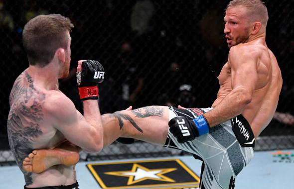 T.J. Dillashaw kicks Corey Sandhagen in their bantamweight fight during the UFC Fight Night event at UFC APEX on July 24, 2021 in Las Vegas, Nevada. (Photo by Jeff Bottari/Zuffa LLC via Getty Images)