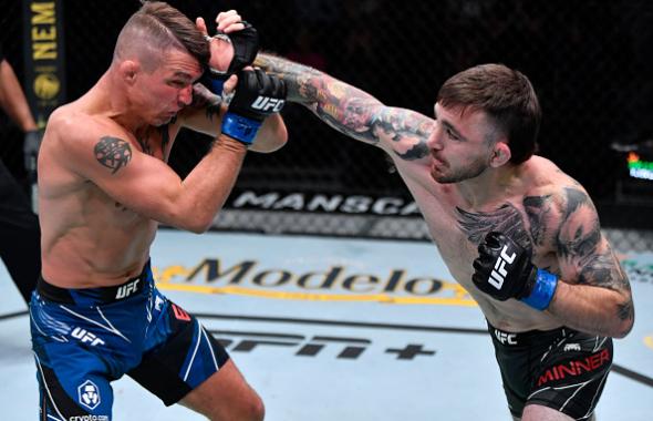 Darrick Minner punches Darren Elkins in their featherweight fight during the UFC Fight Night event at UFC APEX on July 24, 2021 in Las Vegas, Nevada. (Photo by Jeff Bottari/Zuffa LLC)