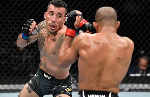 Saimon Oliveira of Brazil punches Tony Gravely in their bantamweight fight during the UFC 270 event at Honda Center on January 22, 2022 in Anaheim, California. (Photo by Chris Unger/Zuffa LLC)