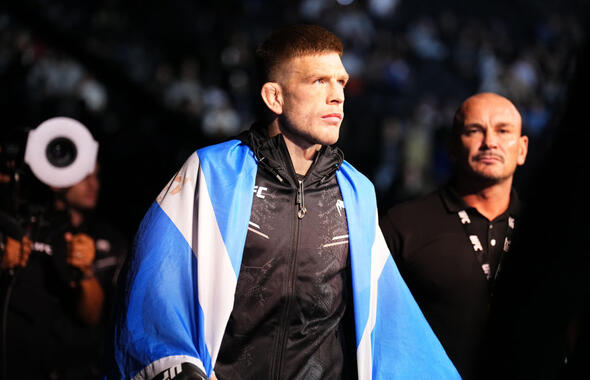 Chris Duncan walks to the Octagon in black UFC gear