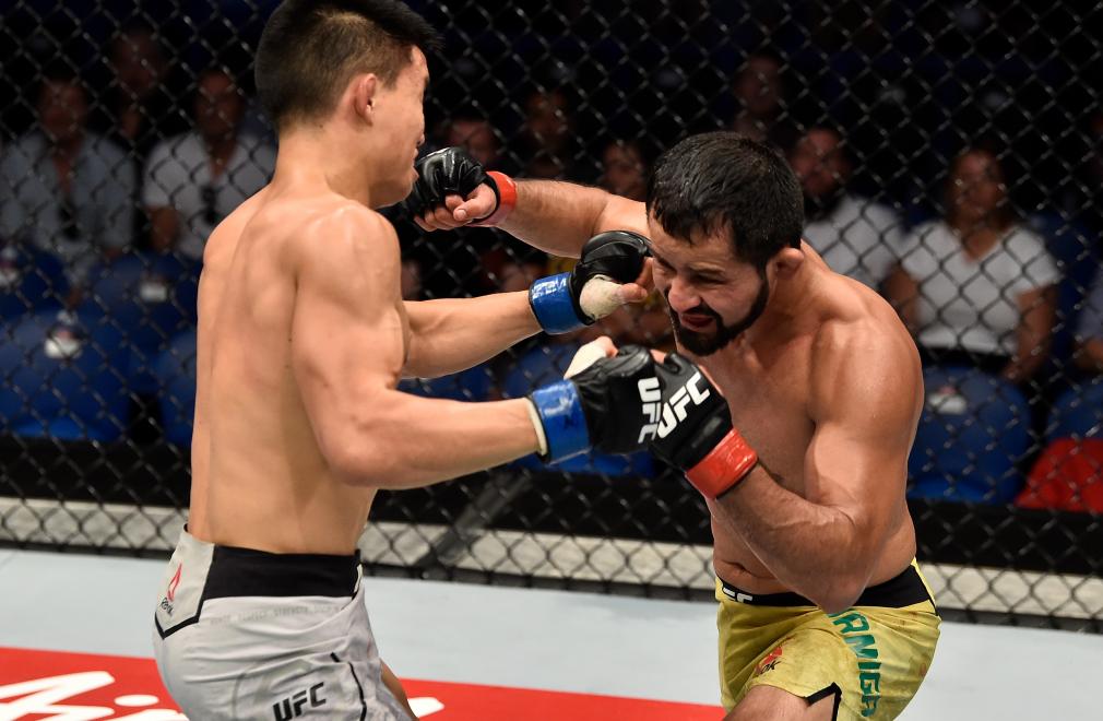 PERTH, AUSTRALIA - FEBRUARY 11: (R-L) Jussier Formiga of Brazil exchanges punches with Ben Nguyen in their flyweight bout during the UFC 221 event at Perth Arena on February 11, 2018 in Perth, Australia. (Photo by Jeff Bottari/Zuffa LLC/Zuffa LLC via Getty Images)