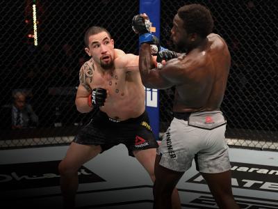  Robert Whittaker of Australia punches Jared Cannonier in their middleweight bout during the UFC 254 event on October 25, 2020 on UFC Fight Island, Abu Dhabi, United Arab Emirates. (Photo by Josh Hedges/Zuffa LLC via Getty Images)