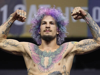 Sean O'Malley poses on the scale during the UFC 269 ceremonial weigh-in at MGM Grand Garden Arena on December 10, 2021 in Las Vegas, Nevada. (Photo by Jeff Bottari/Zuffa LLC)