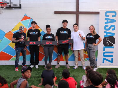Brandon Moreno and Rey Mysterio strike a pose together as UFC and WWE visit Casa De Luz to celebrate Noche UFC in Las Vegas.