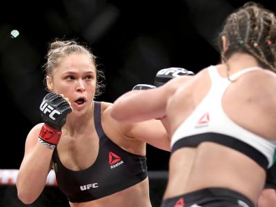 RIO DE JANEIRO, BRAZIL - AUGUST 01:  Ronda Rousey of the United States (red) fights Bethe Correia of Brazi (blue) l in their bantamweight title fight during the UFC 190 Rousey v Correia at HSBC Arena on August 1, 2015 in Rio de Janeiro, Brazil.  (Photo by