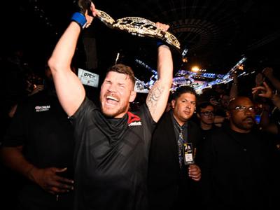INGLEWOOD, CA - JUNE 04:  Michael Bisping of England celebrates with his title belt after his first round knockout win against Luke Rockhold during the UFC 199 event at The Forum on June 4, 2016 in Inglewood, California.  (Photo by Jeff Bottari/Zuffa LLC/