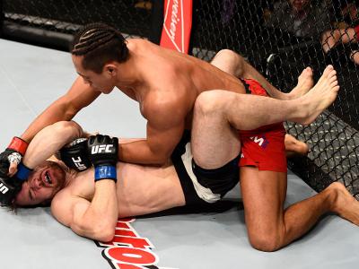 LAS VEGAS, NV - DECEMBER 03: (R-L) Dong Hyun Kim of South Korea punches Brendan O'Reilly of Australia in their lightweight bout during The Ultimate Fighter Finale event inside the Pearl concert theater at the Palms Resort & Casino on December 3, 2016 in L