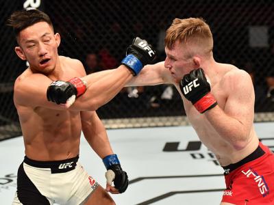 BELFAST, NORTHERN IRELAND - NOVEMBER 19:  (R-L) Brett Johns of Wales punches Kwan Ho Kwak of South Korea in their bantamweight bout during the UFC Fight Night at the SSE Arena on November 19, 2016 in Belfast, Northern Ireland. (Photo by Brandon Magnus/Zuf