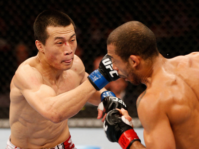 RIO DE JANEIRO, BRAZIL - AUGUST 03:  (L-R) "The Korean Zombie" Chan Sung Jung punches Jose Aldo in their featherweight championship bout during UFC 163 at HSBC Arena on August 3, 2013 in Rio de Janeiro, Brazil. (Photo by Josh Hedges/Zuffa LLC/Zuffa LLC vi