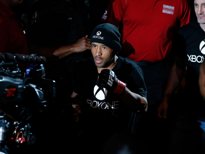 VANCOUVER, BC - JUNE 14:  UFC Flyweight Champion Demetrious 'Mighty Mouse' Johnson enters the arena before facing challenger Ali Bagautinov in their UFC flyweight championship bout at Rogers Arena on June 14, 2014 in Vancouver, Canada.  (Photo by Josh Hed