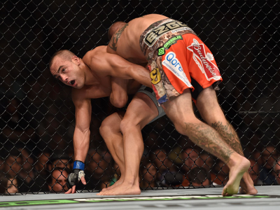 LAS VEGAS, NV - SEPTEMBER 27:  (R-L) Donald Cerrone pushes Eddie Alvarez against the cage in their lightweight fight during the UFC 178 event inside the MGM Grand Garden Arena on September 27, 2014 in Las Vegas, Nevada.  (Photo by Jeff Bottari/Zuffa LLC/Z