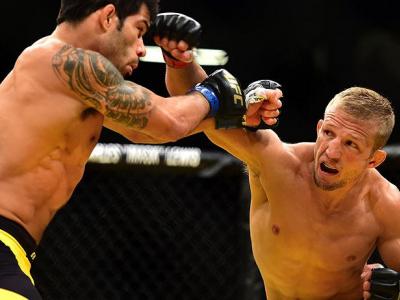 LAS VEGAS, NV - JULY 09: (R-L) TJ Dillashaw punches Raphael Assuncao of Brazil in their bantamweight bout during the UFC 200 event on July 9, 2016 at T-Mobile Arena in Las Vegas, Nevada.  (Photo by Harry How/Zuffa LLC/Zuffa LLC via Getty Images) *** Local