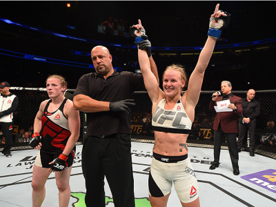 ORLANDO, FL - DECEMBER 19:   (R-L) Valentina Shevchenko celebrates her victory over Sarah Kaufman in their women's bantamweight bout during the UFC Fight Night event at the Amway Center on December 19, 2015 in Orlando, Florida. (Photo by Josh Hedges/Zuffa