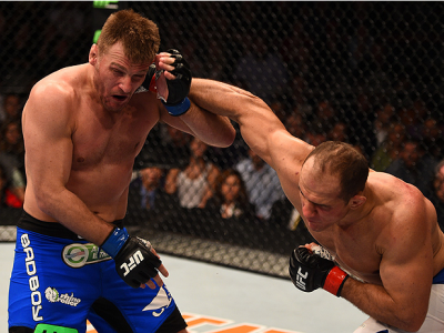 PHOENIX, AZ - DECEMBER 13:  (R-L) Junior Dos Santos of Brazil punches Stipe Miocic in their heavyweight fight during the UFC Fight Night event at the U.S. Airways Center on December 13, 2014 in Phoenix, Arizona.  (Photo by Josh Hedges/Zuffa LLC/Zuffa LLC 
