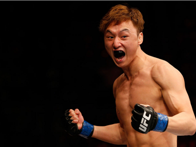 AUSTIN, TX - NOVEMBER 22:  Doo Ho Choi of South Korea celebrates after his TKO victory over Juan Puig of Mexico in their featherweight bout during the UFC Fight Night event at The Frank Erwin Center on November 22, 2014 in Austin, Texas.  (Photo by Josh H
